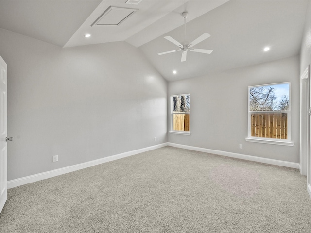 carpeted empty room with vaulted ceiling, a wealth of natural light, and ceiling fan