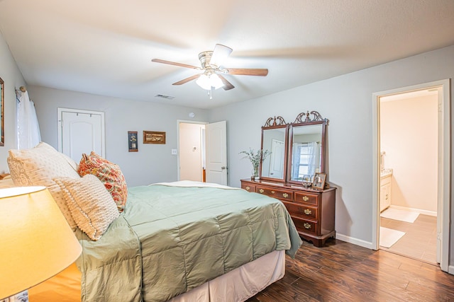 bedroom featuring ceiling fan, connected bathroom, and dark hardwood / wood-style flooring