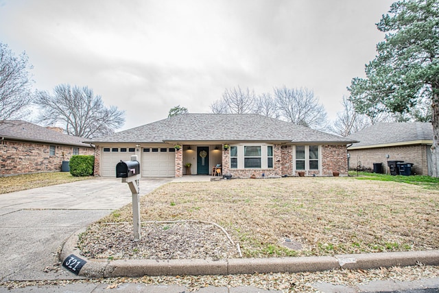 ranch-style home featuring a garage and a front lawn