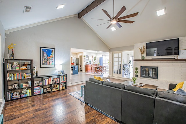 living room with high vaulted ceiling, a fireplace, beamed ceiling, ceiling fan, and dark wood-type flooring