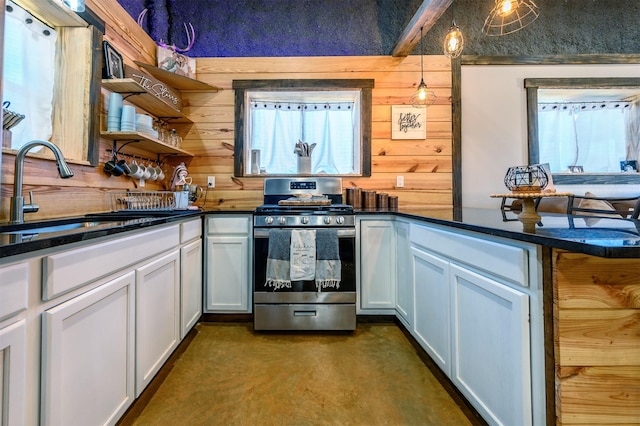 kitchen with white cabinets, decorative light fixtures, sink, and stainless steel gas stove