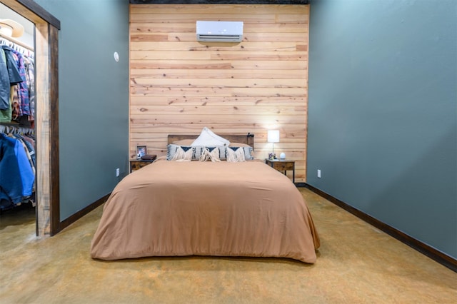 bedroom featuring wooden walls, a closet, and a wall mounted AC