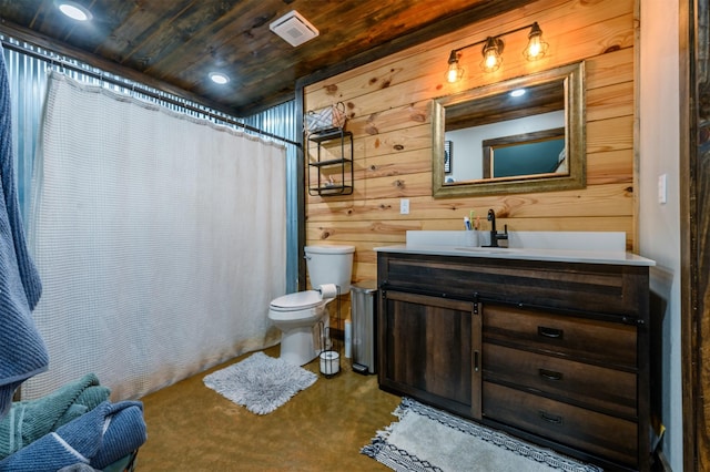 bathroom featuring vanity, a shower with curtain, wooden walls, and toilet