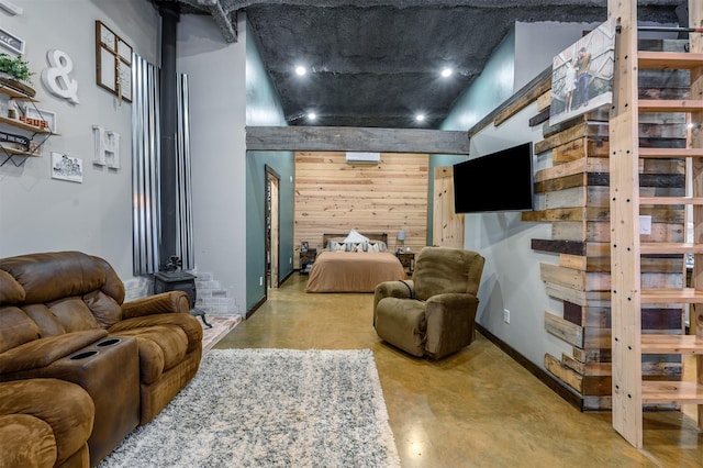 bedroom featuring concrete flooring and wood walls