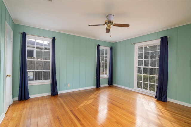 unfurnished room with ceiling fan, ornamental molding, and wood-type flooring