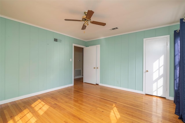 unfurnished room with ornamental molding, hardwood / wood-style floors, and ceiling fan