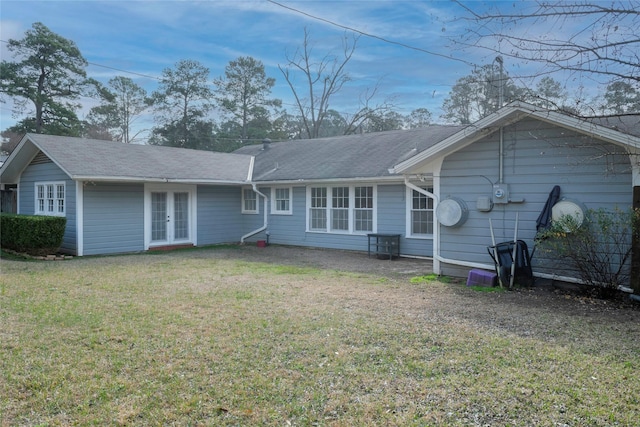 rear view of property with a yard