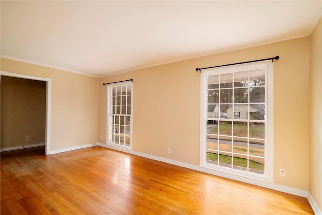 unfurnished room with crown molding and hardwood / wood-style flooring