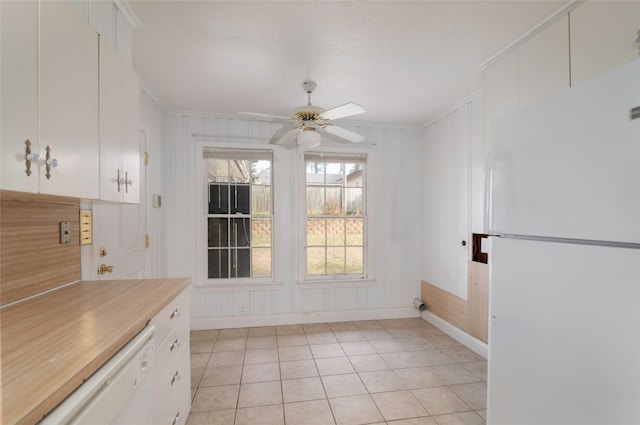 unfurnished dining area featuring light tile patterned flooring, ceiling fan, plenty of natural light, and ornamental molding