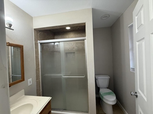 bathroom featuring walk in shower, vanity, and toilet