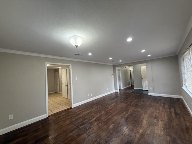 spare room featuring crown molding and light hardwood / wood-style flooring