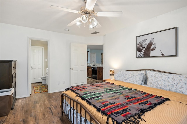 bedroom with beverage cooler, baseboards, visible vents, dark wood-style flooring, and ensuite bathroom