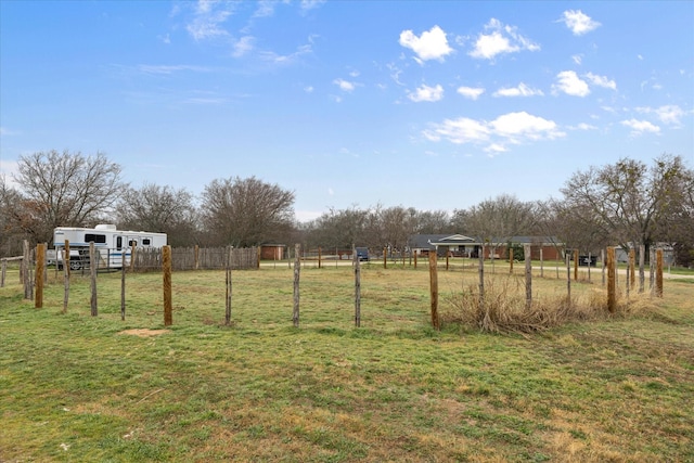 view of yard featuring fence and a rural view