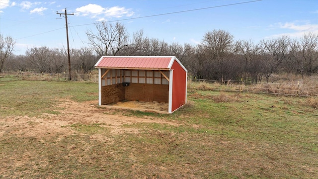 view of pole building featuring a yard and fence