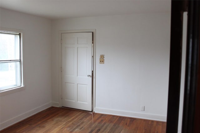 unfurnished room featuring dark hardwood / wood-style floors