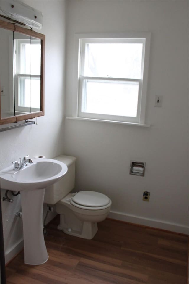 bathroom with toilet and hardwood / wood-style floors