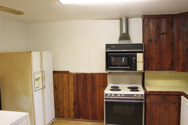 kitchen featuring tile counters and white appliances