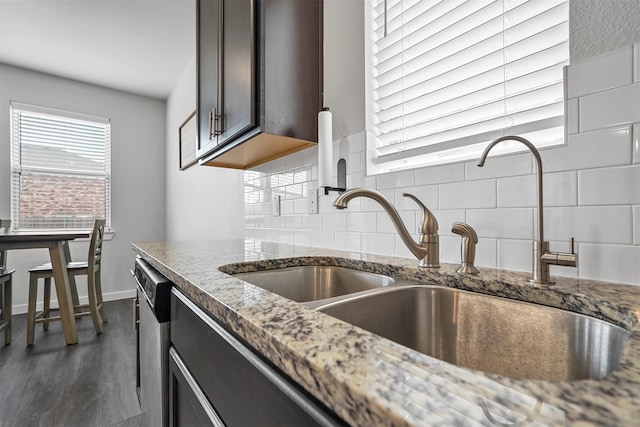 kitchen with tasteful backsplash, sink, and dark stone counters