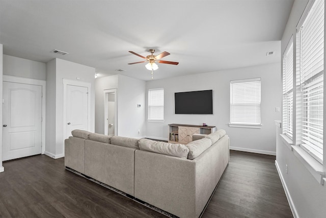 living room featuring ceiling fan and dark hardwood / wood-style flooring