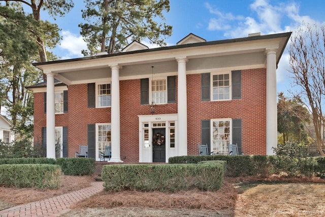 neoclassical home featuring covered porch