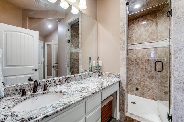 bathroom featuring an enclosed shower and vanity