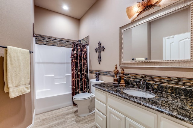 full bathroom featuring shower / tub combo with curtain, vanity, and toilet