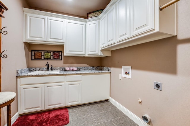 clothes washing area with sink, cabinets, electric dryer hookup, washer hookup, and hookup for a gas dryer