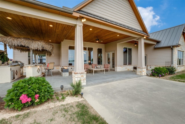 back of property featuring a patio, ceiling fan, and exterior kitchen