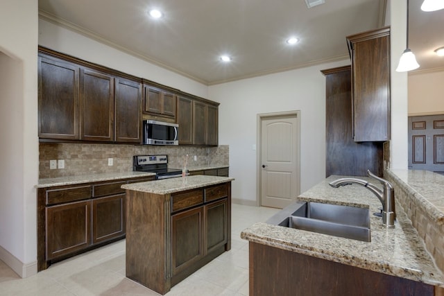 kitchen featuring pendant lighting, sink, dark brown cabinetry, and appliances with stainless steel finishes