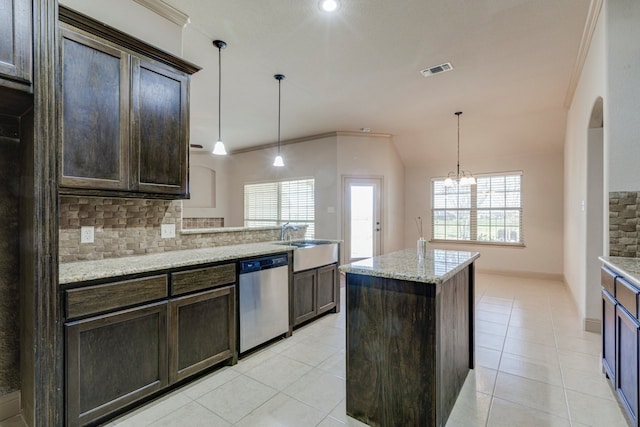 kitchen with decorative light fixtures, dark brown cabinets, light stone countertops, and dishwasher