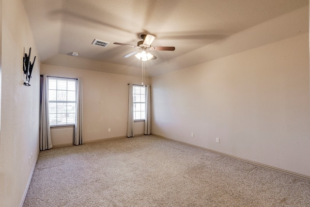 carpeted spare room with ceiling fan