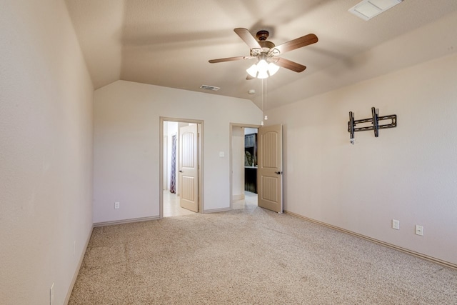 unfurnished bedroom with light carpet, lofted ceiling, and ceiling fan