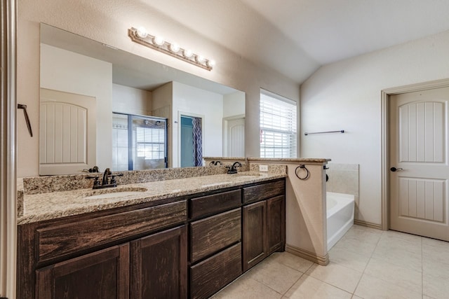 bathroom with shower with separate bathtub, vaulted ceiling, tile patterned floors, and vanity