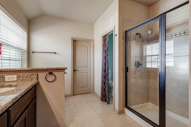 bathroom with tile patterned flooring, vanity, lofted ceiling, and an enclosed shower