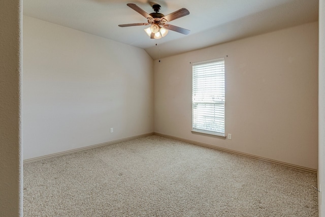 carpeted spare room featuring ceiling fan and lofted ceiling