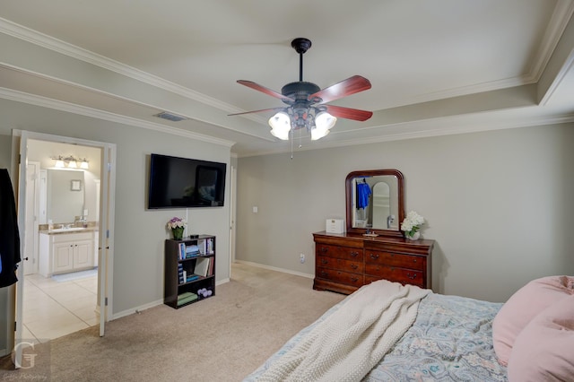 carpeted bedroom with connected bathroom, sink, ornamental molding, ceiling fan, and a raised ceiling