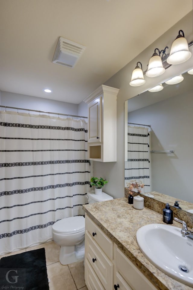 bathroom featuring tile patterned flooring, vanity, and toilet