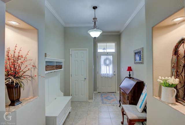 foyer entrance featuring light tile patterned floors and ornamental molding