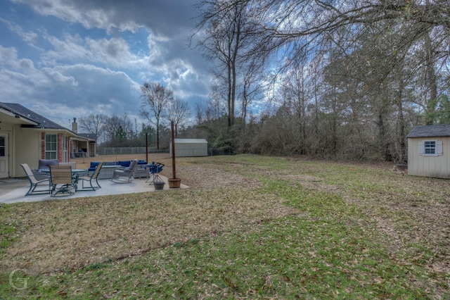 view of yard featuring a patio and a shed