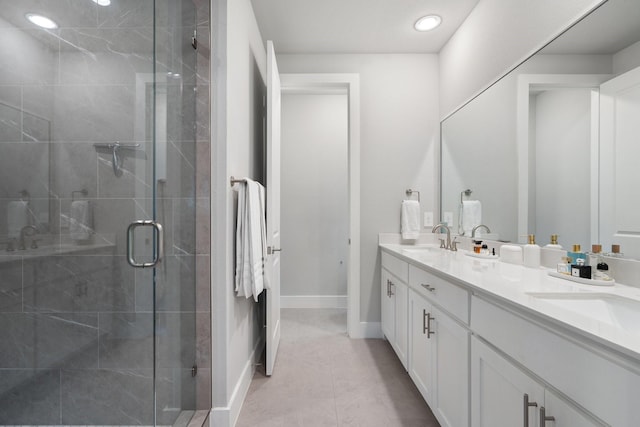 bathroom with vanity, a shower with shower door, and tile patterned flooring