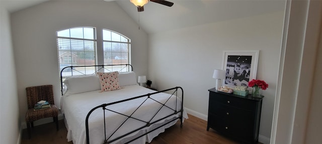 bedroom featuring ceiling fan, lofted ceiling, and dark hardwood / wood-style flooring