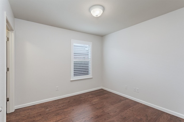 empty room featuring dark hardwood / wood-style flooring