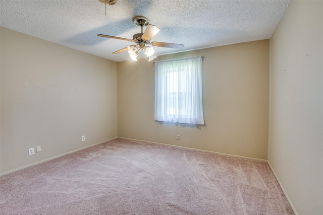 carpeted spare room with ceiling fan and a textured ceiling