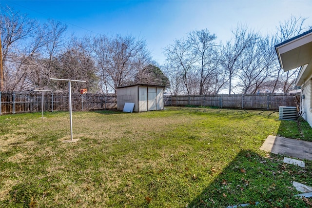 view of yard with central AC and a storage shed