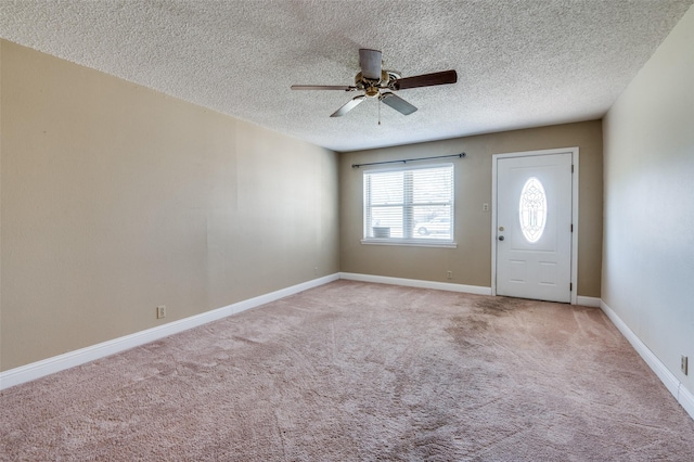 entrance foyer with light colored carpet, a textured ceiling, and ceiling fan