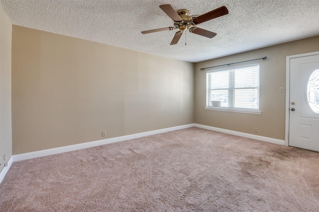 foyer with ceiling fan, light colored carpet, and a textured ceiling