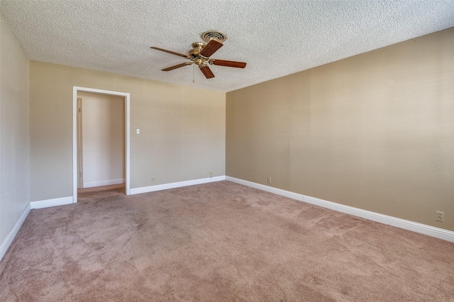 empty room featuring ceiling fan, a textured ceiling, and carpet flooring