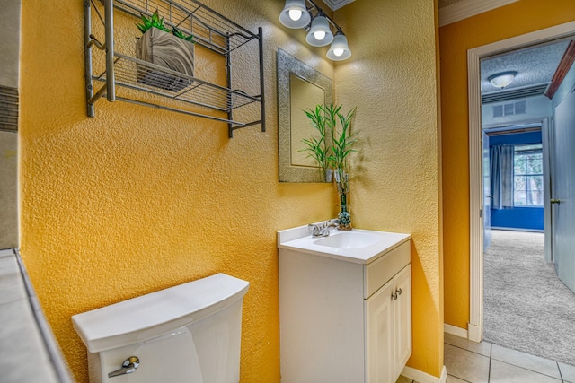 bathroom featuring ornamental molding, toilet, tile patterned flooring, and vanity