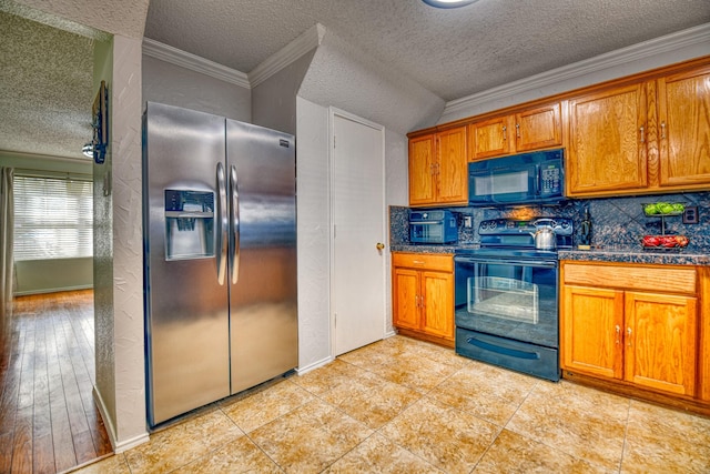 kitchen featuring light tile patterned flooring, crown molding, black appliances, a textured ceiling, and backsplash