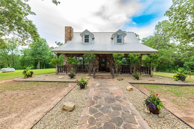 view of front of property with covered porch and a front lawn